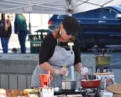 Photo of woman conducting cooking demonstration at Sheridan Farmers Market